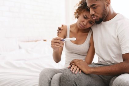 Couple shows concerned faces looking at pregnancy or fertility test