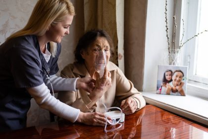 Clinician holding oxygen on COPD patient's face