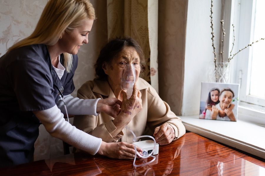 Clinician holding oxygen on COPD patient's face