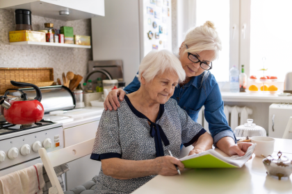 Daughter helping elderly mother