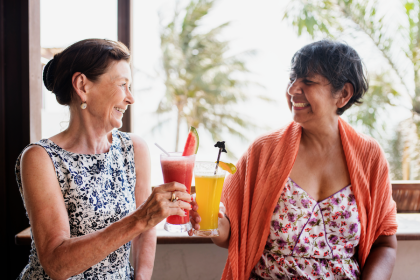 Two elderly women drinking beverages to prevent dehydration