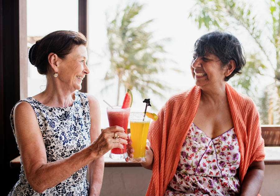 Two elderly women drinking beverages to prevent dehydration